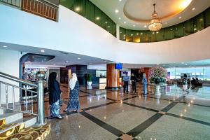 people walking in the lobby of a building at New York Hotel in Johor Bahru +66 photos