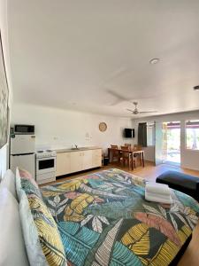 a living room with a couch and a kitchen at Sunlodge Caravan Park in Hervey Bay
