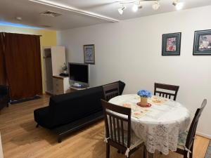 ein Wohnzimmer mit Tisch, Stühlen und Fernseher in der Unterkunft Motel Rayalco in Laurier Station