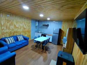 a living room with a blue couch and a table at Siloe in Coihaique +12 photos