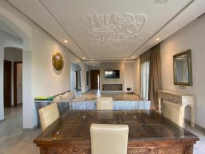 a dining room with a table and chairs at Villa nomad marrakech in Douar bel Rhanodour