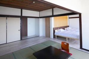 a bedroom with a bed and a table at 海凪旅館 in Tateyama +125 photos