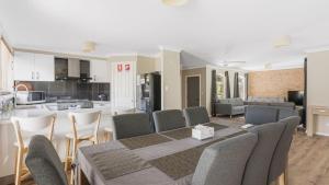 a kitchen and living room with a table and chairs at Boater's Retreat - pet friendly, right off the M1 in Toormina