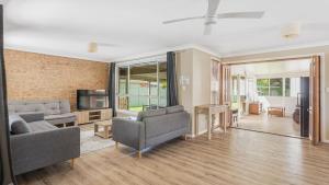 a living room with two couches and a tv at Boater's Retreat - pet friendly, right off the M1 in Toormina