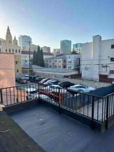 a parking lot with cars parked in a city at KTown Sanctuary Soul in Los Angeles