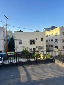 a building with a fence in front of a street at KTown Sanctuary Soul in Los Angeles