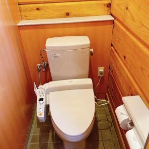 a small bathroom with a toilet in a room at Yubari Forest Farm BandB in Yubari