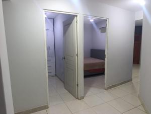 a room with two doors with a bed in it at Minidepartamento Centro de Huanuco in Huánuco +5 photos