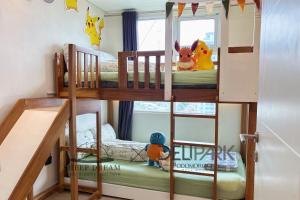 two bunk beds in a small room with a window at SheepDream 7DI DeliparkMall 2Bedroom, 1Bathroom in Medan