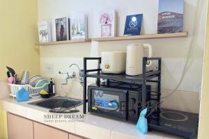 a kitchen counter with a microwave on a counter top at SheepDream 7DI DeliparkMall 2Bedroom, 1Bathroom in Medan