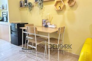 a kitchen with a table and chairs and a refrigerator at SheepDream 7DI DeliparkMall 2Bedroom, 1Bathroom in Medan