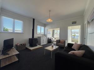 a living room with a couch and a tv at Wilmas by the Bay in Riverton