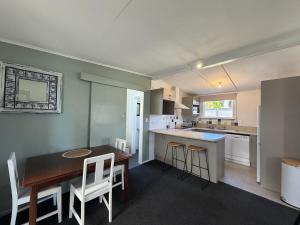 a kitchen and dining room with a table and chairs at Wilmas by the Bay in Riverton +16 photos