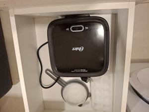 a toilet paper dispenser in a bathroom stall at Dpto Resort zona aeropuerto in Luque +35 photos