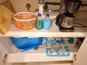 a kitchen shelf with bottles of water and a blender at Dpto Resort zona aeropuerto in Luque