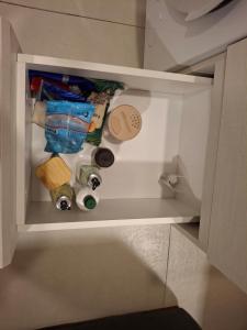 a drawer in a cabinet filled with food and drinks at Dpto Resort zona aeropuerto in Luque
