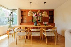 a dining room with a wooden table and chairs at Amazing TERRAZO place, 8 guest!! 4 beds in Mexico City