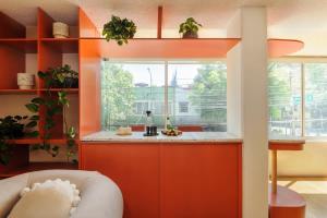 an orange kitchen with a sink and a window at Amazing TERRAZO place, 8 guest!! 4 beds in Mexico City