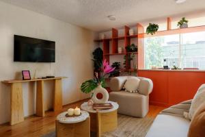 a living room with a couch and a tv at Amazing TERRAZO place, 8 guest!! 4 beds in Mexico City