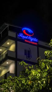 a blue and red sign on the side of a building at Royal Agate Beach Resort in Pantai Cenang