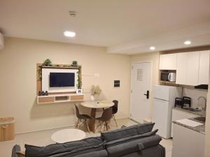 a living room with a couch and a table at Dpto Resort zona aeropuerto in Luque