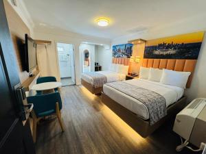 a hotel room with two beds and a table at The Lexmar - Dodger Stadium-Convention Center in Los Angeles