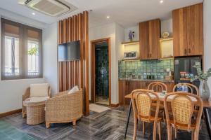 a kitchen and dining room with a table and chairs at Ciao Boutique Danang - New Hotel Opening April 2026 in Danang