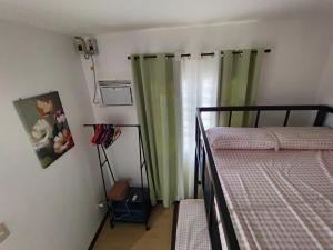a bedroom with two bunk beds and a window at Sorelle Haven II in Manolo Fortich +3 photos