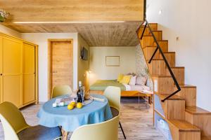 a living room with a table and a bedroom at Penzion U Kapličky in Znojmo