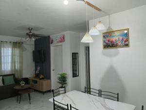 a dining room and living room with a dining table at Sorelle Haven II in Manolo Fortich