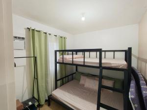 a bedroom with two bunk beds in a room at Sorelle Haven II in Manolo Fortich