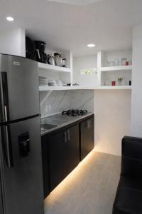 a kitchen with a stainless steel refrigerator and a stove at Refugio Rio Santo in Las Alfombras