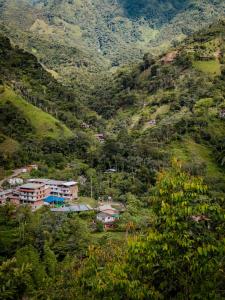 a village on a hillside with houses and trees at Refugio Rio Santo in Las Alfombras +9 photos