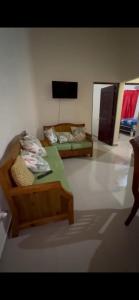 a room with two beds and a flat screen tv at Mi casita en Jaraba in Jarabacoa