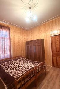 a bedroom with a bed and a chandelier at BibO in Martvili