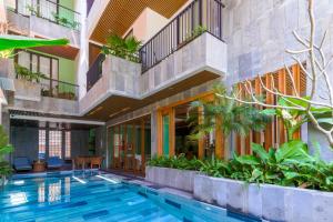 a swimming pool in a building with plants at Ciao Boutique Danang - New Hotel Opening April 2026 in Danang