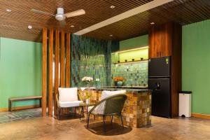 a kitchen with a table and chairs and a refrigerator at Ciao Boutique Danang - New Hotel Opening April 2026 in Danang +80 photos
