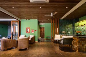 a lobby with chairs and a green wall at Ciao Boutique Danang - New Hotel Opening April 2026 in Danang