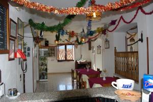 a restaurant with christmas decorations on the ceiling and tables at Le Due Lanterne in Aieta