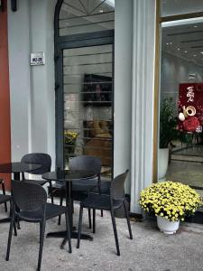 a group of tables and chairs in front of a store at HS Dobry Hotel Ha Long in Ha Long