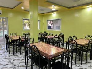 a room with tables and chairs and green walls at Group stay Pangasinan in Bugallon