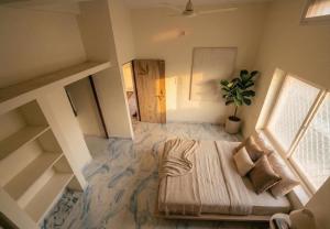 a bedroom with a bed and a potted plant at Greenwood stay in Bhilai