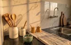 a kitchen counter with wooden utensils on a cutting board at Greenwood stay in Bhilai