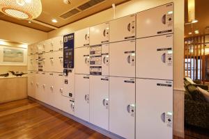a row of lockers in a room at Yamatoya Honten Ryokan Osaka in Osaka