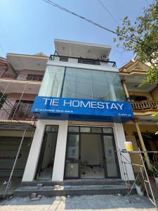 a building with a blue sign on the front of it at Tie Homestay in Dong Hoi +29 photos