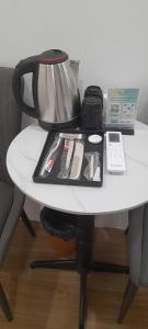 a table with a tea pot and a phone on it at Green Nest Hotel in Hanoi