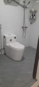 a bathroom with a white toilet in a room at Green Nest Hotel in Hanoi