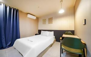 a small room with a bed and a chair at Bucheon The Seollelm Hotel Stay in Bucheon +19 photos