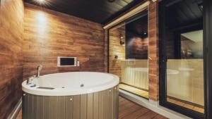 a large bathroom with a tub and a window at ZABOCON Yoichi Villa in Yoichi