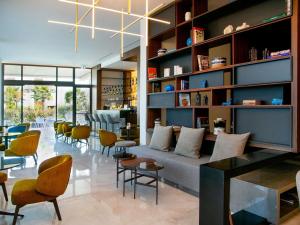 a living room with a couch and chairs at Mercure Larnaca Beach Resort in Larnaca